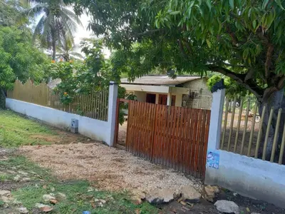 a fence with a wooden gate in front of a house at Villa Lexis in Coveñitas