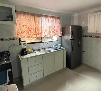 a small kitchen with a sink and a refrigerator at Ritze's House Getsemani in Cartagena de Indias