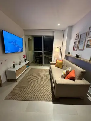 a living room with a couch and a flat screen tv at Baia Kristal Kabo Apartamento in Cartagena de Indias