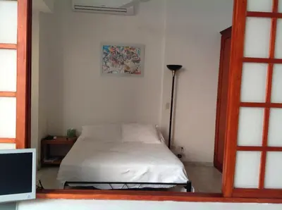 a bedroom with a bed and a lamp in it at Loft in Old Town, Cartagena in Cartagena de Indias