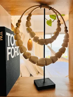a wooden rosary on a stand in a room at Casa Manalva ocean view penthouse in walled city in Cartagena de Indias
