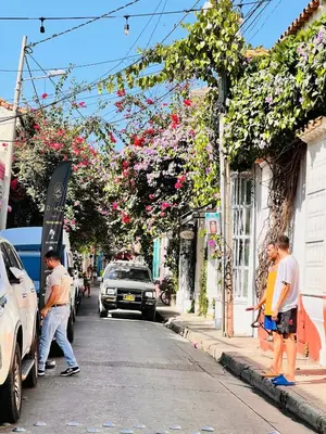 a group of people standing on the side of a street at Casa Manalva ocean view penthouse in walled city in Cartagena de Indias