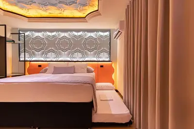 a bedroom with a large bed and a window at Casa Stella Rooms in Cartagena de Indias