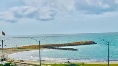 a beach in the ocean with people on it at Cabrero Beach 507 in Cartagena de Indias