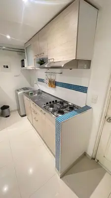 a white kitchen with a stove top oven in it at Cabrero Beach 507 in Cartagena de Indias