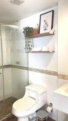 a white bathroom with a toilet and a sink at Cabrero Beach 507 in Cartagena de Indias