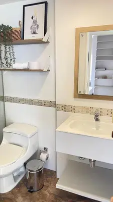 a bathroom with a toilet and a sink and a mirror at Cabrero Beach 507 in Cartagena de Indias