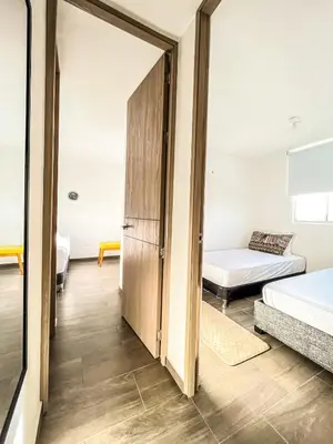 a room with two beds and a closet at Apartamento Ideal cerca de Zona Industrial, Terminal y Centro Comercial in Cartagena de Indias