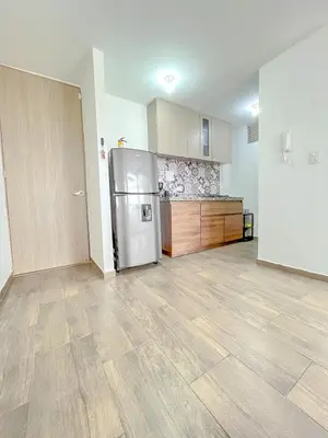 an empty kitchen with a refrigerator in a room at Apartamento Ideal cerca de Zona Industrial, Terminal y Centro Comercial in Cartagena de Indias
