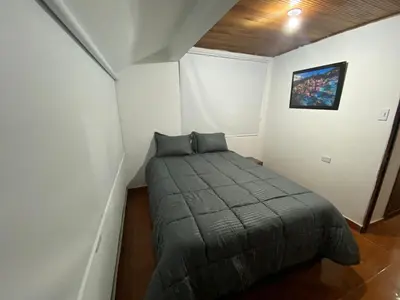a small bedroom with a bed in a room at Modern duplex 5 minutes from the Historic Center in Cartagena de Indias