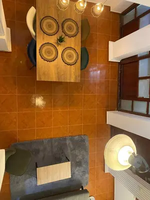 a kitchen with a tile wall with a clock on it at Modern duplex 5 minutes from the Historic Center in Cartagena de Indias