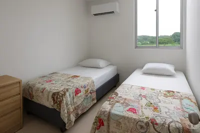 a bedroom with two beds and a window at Mirador de la Reserva Coveñas in Coveñas