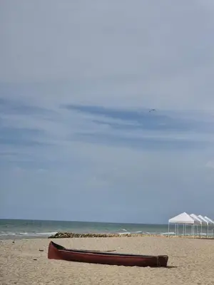 a boat sitting on a beach with an umbrella at Mirador de la Reserva Coveñas in Coveñas