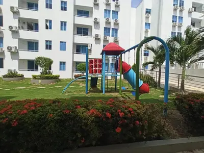 a playground in a park in front of a building at Mirador de la Reserva Coveñas in Coveñas