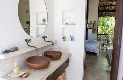 a bathroom with two sinks and a mirror at Villa Frente al mar en el Calao, San Antero in Calao