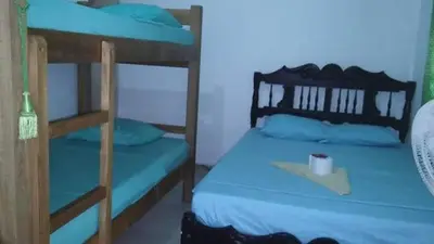 a bedroom with two bunk beds with blue pillows at Playas el paraiso in San Bernardo del Viento