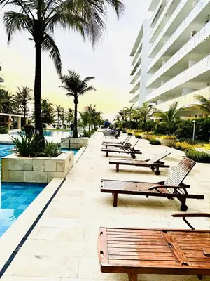 a row of benches next to a pool at a resort at Apartamento en Cartagena con balcón en Morros in Cartagena de Indias