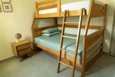 a bunk bed with a ladder next to a night stand at Beach house in Cartagena de Indias