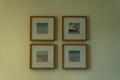 a group of four pictures on a wall at Beach house in Cartagena de Indias