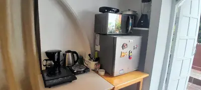 a kitchen counter with a refrigerator and a microwave at apartamento 3 habitaciones totalmente equipado in Cartagena de Indias