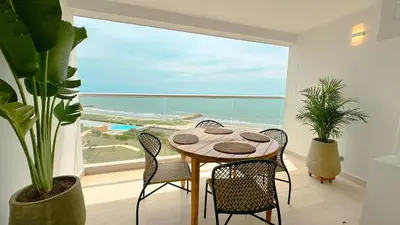a dining room with a table and a view of the ocean at Charming Oceanfront Apartment with Balcony and Panoramic view, Cartagena Colombia in Cartagena de Indias