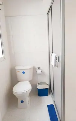 a small bathroom with a toilet and a blue rug at apto en casa centro historico 3 piso in Cartagena de Indias