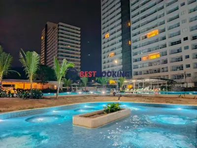 a swimming pool in front of a building at night at Santa Marina Luxury Stay - Ocean View in Estación El Salto