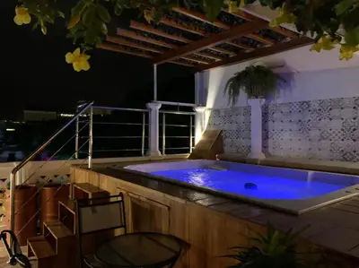 a jacuzzi tub on a balcony at night at Casa Mary Hotel in Cartagena de Indias