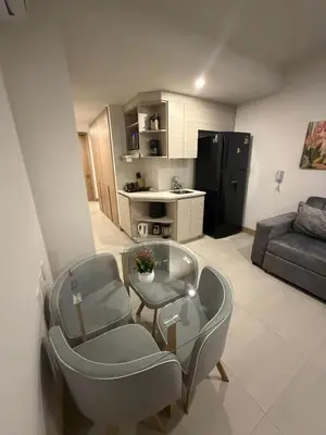 a living room with a couch and a table and chairs at Apartaestudio con Jacuzzi Privado y Vista al Mar in Cartagena de Indias