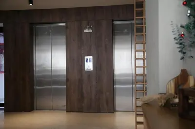 three elevators in a room with a christmas tree at Enjoy the sun and beach in our apartment in Cartagena de Indias