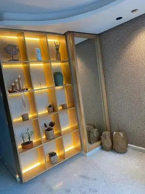 a room with a wall of shelves with potted plants at Enjoy the sun and beach in our apartment in Cartagena de Indias