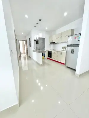 a large white kitchen with white floors and appliances at Apto espectacular frente al mar in Coveñas