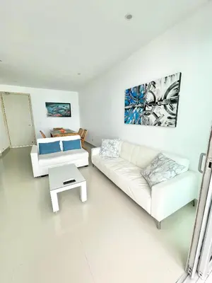 a white living room with a couch and a table at Apto espectacular frente al mar in Coveñas