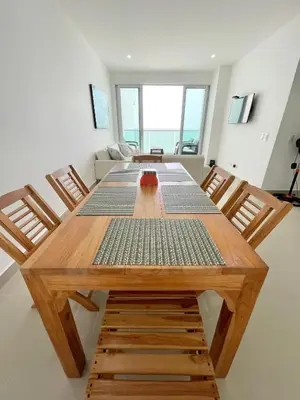 a dining room with a wooden table and chairs at Apto espectacular frente al mar in Coveñas