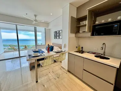 a kitchen with a table and a view of the ocean at Loft Vistas Mar. Crespo Piscina in Cartagena de Indias