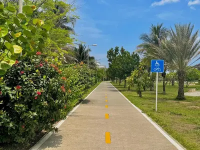 a bike path in a park with a blue sign at Loft Vistas Mar. Crespo Piscina in Cartagena de Indias