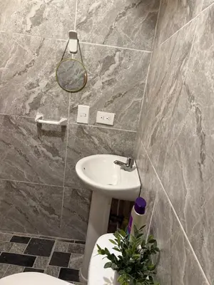 a bathroom with a sink and a toilet and a mirror at Habitación 1 persona cerca de aeropuerto,terminal de buses y estadio in Soledad