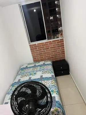 a room with a fan on a bed with a window at Habitación 1 persona cerca de aeropuerto,terminal de buses y estadio in Soledad