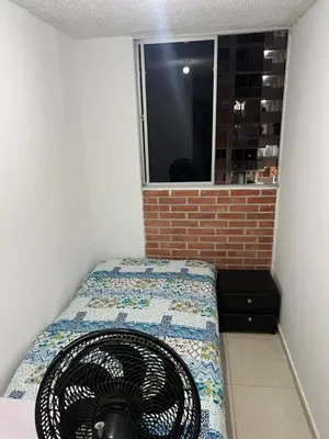 a room with a fan sitting on a bed at Habitación 1 persona cerca de aeropuerto,terminal de buses y estadio in Soledad