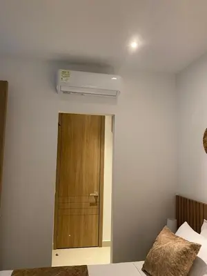 a bedroom with a wooden door and a air conditioner at Cartagena Baia kristal Getaway in Cartagena de Indias