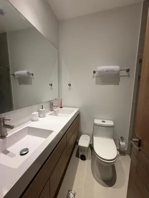 a bathroom with a toilet and a sink and a mirror at Cartagena Baia kristal Getaway in Cartagena de Indias