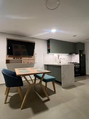 a kitchen with a wooden table and chairs in a kitchen at Alma Kalamari 24 in Cartagena de Indias