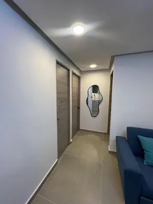 a hallway with a blue couch and a door at Alma Kalamari 24 in Cartagena de Indias