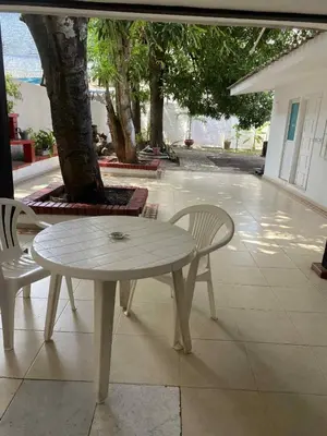 a white table and chairs sitting on a patio at Habitación cerca al aeropuerto # 4 in Cartagena de Indias