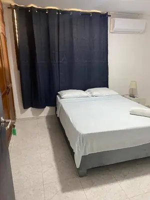 a bed in a room with a black curtain at Habitación cerca al aeropuerto # 4 in Cartagena de Indias