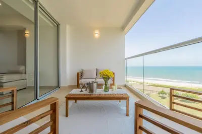 a living room with a table and a view of the ocean at Charming Seafront Loft in Cartagena de Indias