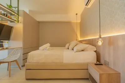 a bedroom with a bed and a table and a desk at Charming Seafront Loft in Cartagena de Indias