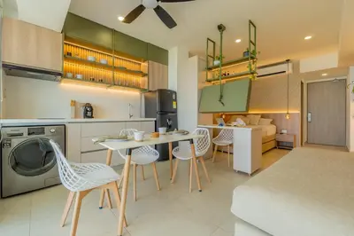 a kitchen and living room with a table and chairs at Charming Seafront Loft in Cartagena de Indias