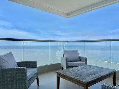 a living room with a table and chairs and a large window at Oceanview Bocagrande Laguito Palmetto Sunset Building in Cartagena de Indias