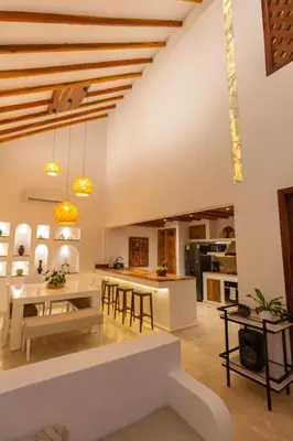 a kitchen and living room with a table and chairs at Casa Bali Castillo View Private Pool & Rooftop, Near Historic Center in Cartagena de Indias